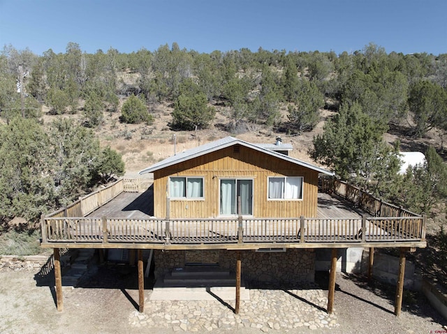 back of house featuring a wooden deck