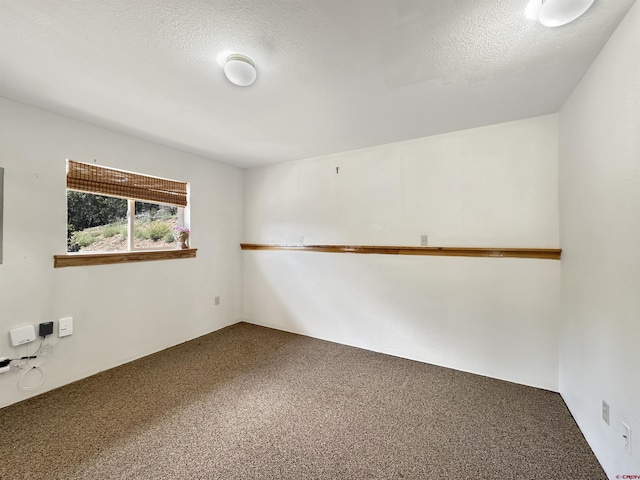 carpeted spare room featuring a textured ceiling