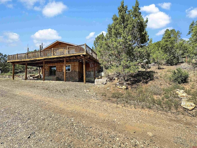 rear view of house with a wooden deck