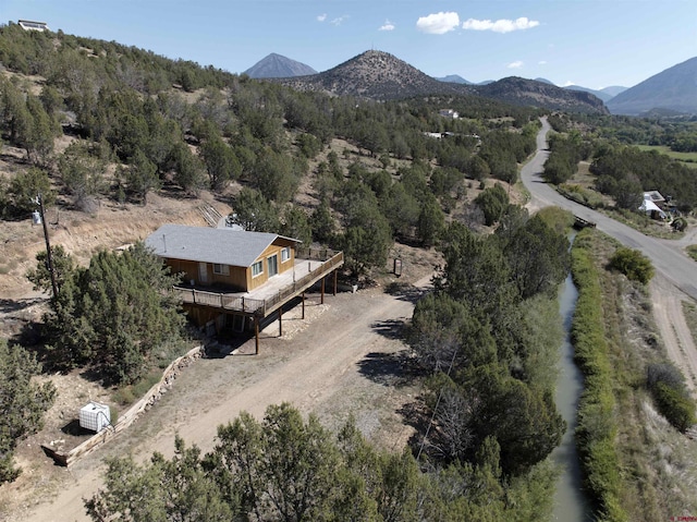 aerial view featuring a mountain view and a forest view