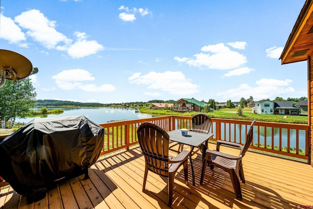 wooden terrace with a grill and a water view