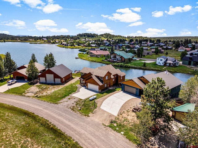 birds eye view of property featuring a residential view and a water view