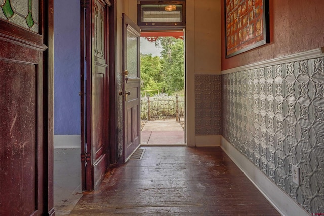 doorway with wainscoting and hardwood / wood-style floors