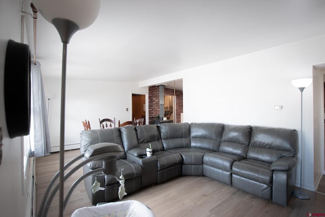 living room featuring baseboard heating and light hardwood / wood-style flooring