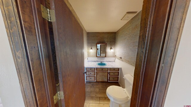 bathroom featuring toilet, hardwood / wood-style flooring, and vanity