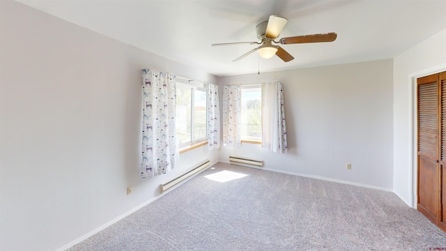 spare room with a baseboard radiator, ceiling fan, and carpet floors