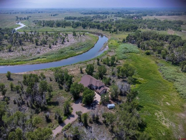 birds eye view of property featuring a water view and a rural view