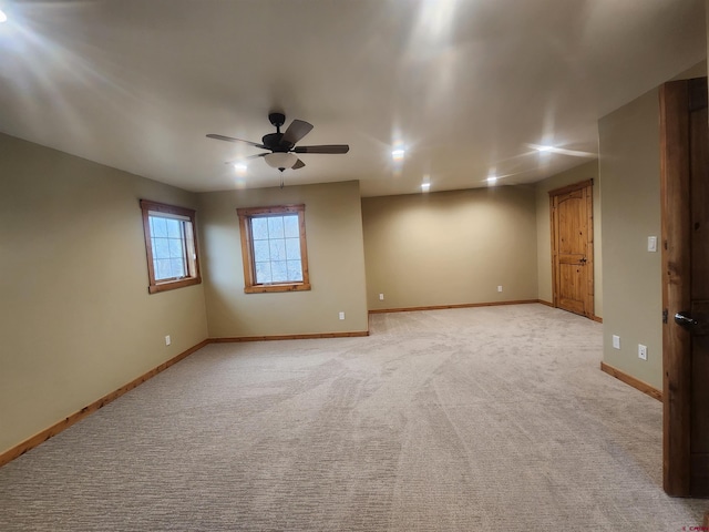 unfurnished room with ceiling fan and light colored carpet