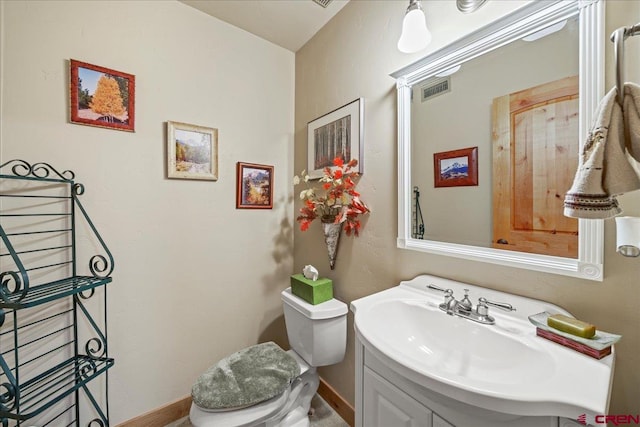 bathroom featuring toilet and vanity