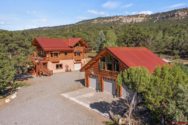 log home with a garage and a mountain view