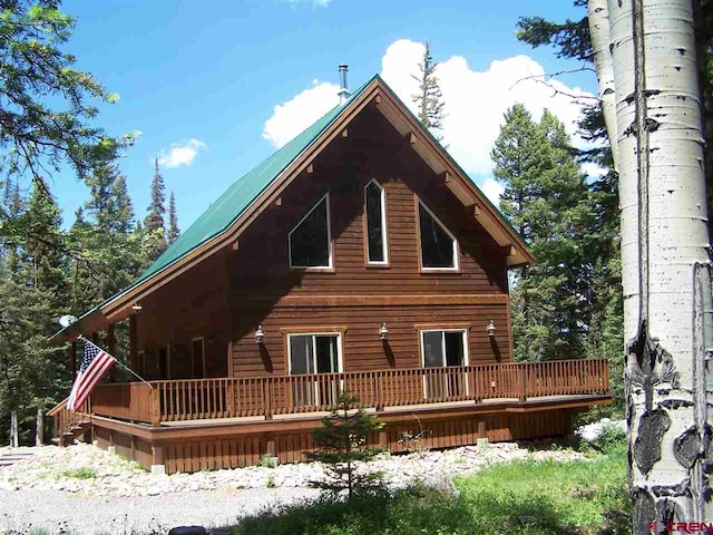 back of property with a wooden deck