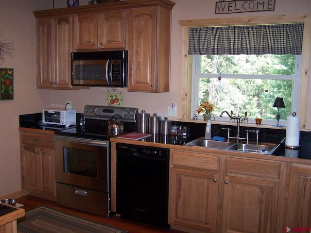 kitchen with stainless steel electric stove, a toaster, a sink, dishwasher, and dark countertops