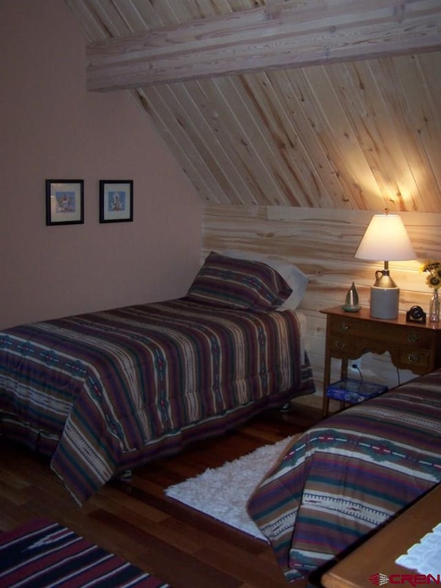 bedroom featuring wooden ceiling, lofted ceiling with beams, and wood finished floors