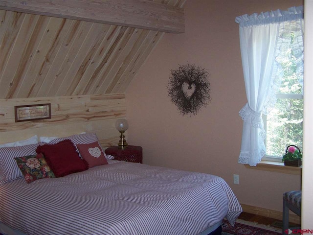 bedroom featuring lofted ceiling with beams