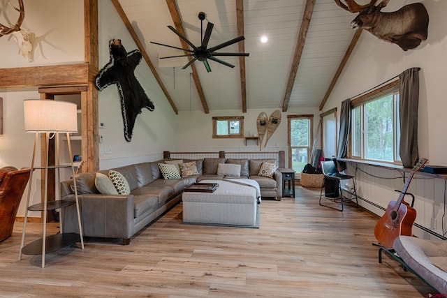 living area with high vaulted ceiling, a ceiling fan, light wood-type flooring, wooden ceiling, and beam ceiling