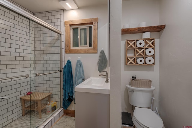 bathroom with a shower stall, toilet, and vanity