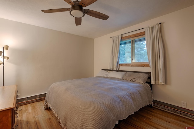 bedroom with wood finished floors and a ceiling fan
