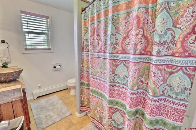 bathroom with tile patterned floors, toilet, a shower with curtain, a baseboard radiator, and vanity