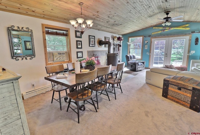 carpeted dining space with ceiling fan with notable chandelier, a wood stove, a baseboard radiator, wood ceiling, and lofted ceiling