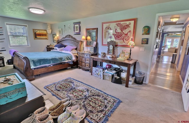 carpeted bedroom with a textured ceiling