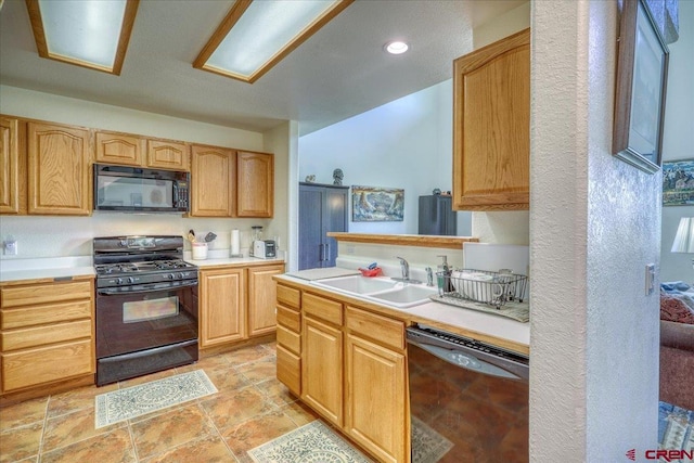 kitchen with black appliances and sink