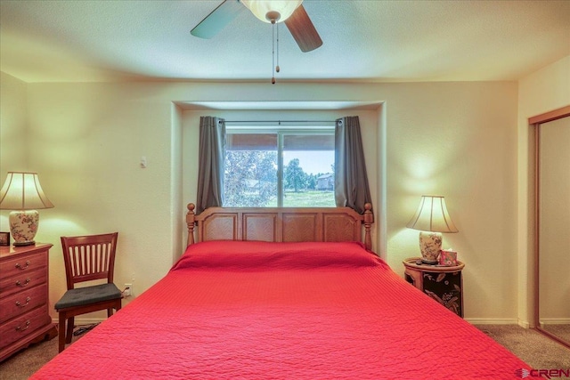 bedroom with ceiling fan, carpet, and a textured ceiling