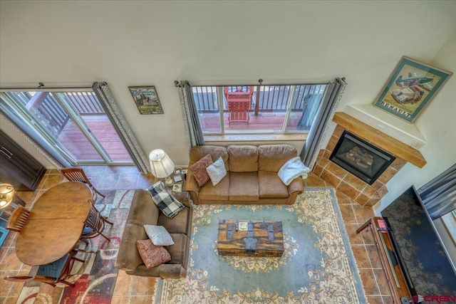 living room with a tile fireplace