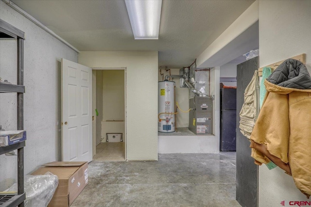 basement featuring gas water heater, heating unit, and a textured ceiling