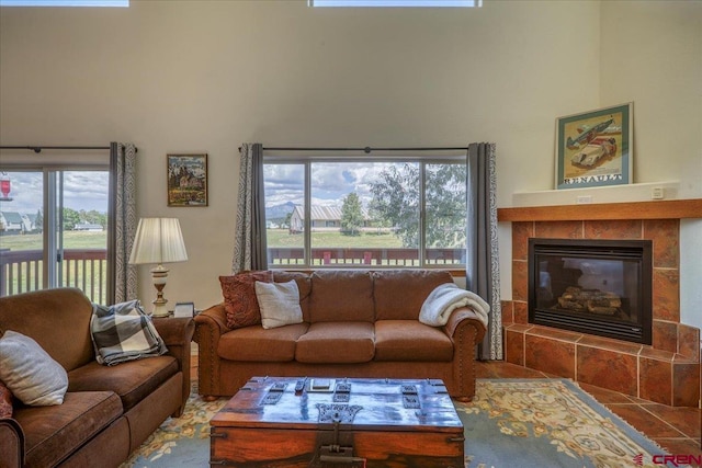 living room with a healthy amount of sunlight and a tile fireplace