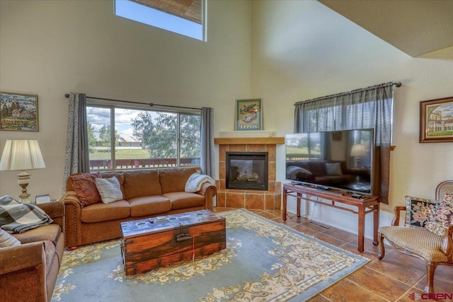 living room with a tiled fireplace and tile patterned floors