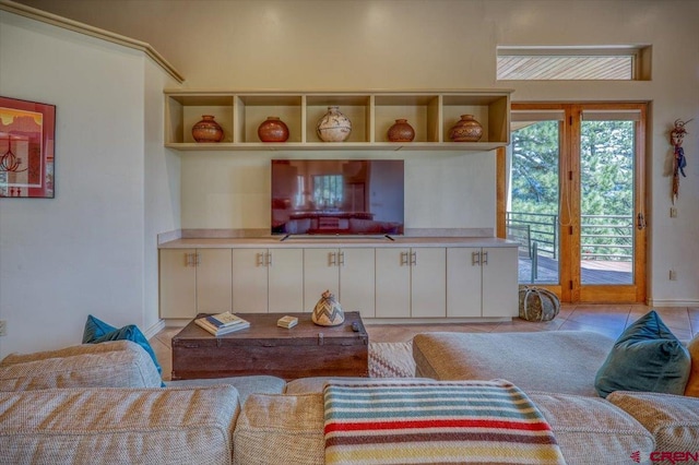 living room featuring light tile patterned floors and french doors