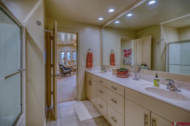 bathroom with tile patterned floors, an enclosed shower, and vanity