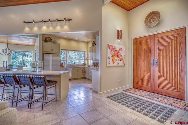 interior space featuring a healthy amount of sunlight, hanging light fixtures, a breakfast bar, and appliances with stainless steel finishes