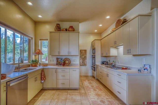 kitchen featuring light tile patterned flooring, stainless steel appliances, and sink