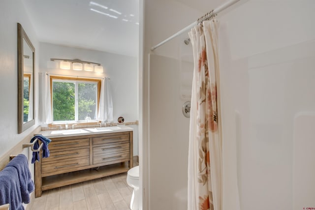 bathroom featuring vanity, toilet, a shower with shower curtain, and hardwood / wood-style flooring