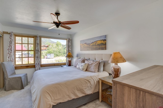 bedroom featuring ceiling fan and light colored carpet