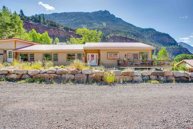 view of front of property featuring a deck with mountain view