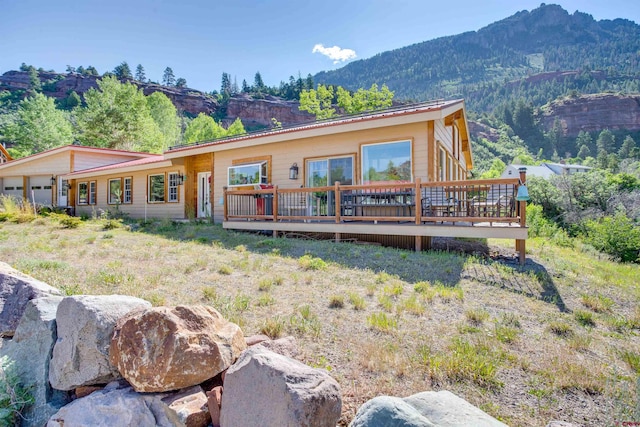 back of house featuring a deck with mountain view