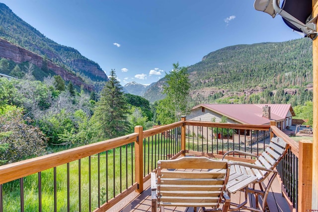 exterior space featuring a mountain view and a lawn