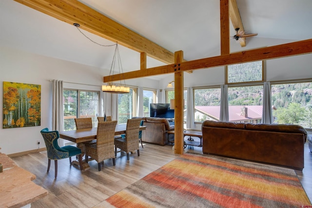 dining space featuring hardwood / wood-style floors, ceiling fan, and vaulted ceiling with beams