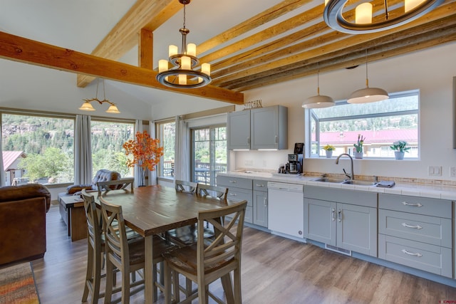 kitchen with dishwasher, decorative light fixtures, a chandelier, sink, and beam ceiling