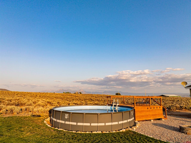 view of property's community with a swimming pool and a mountain view