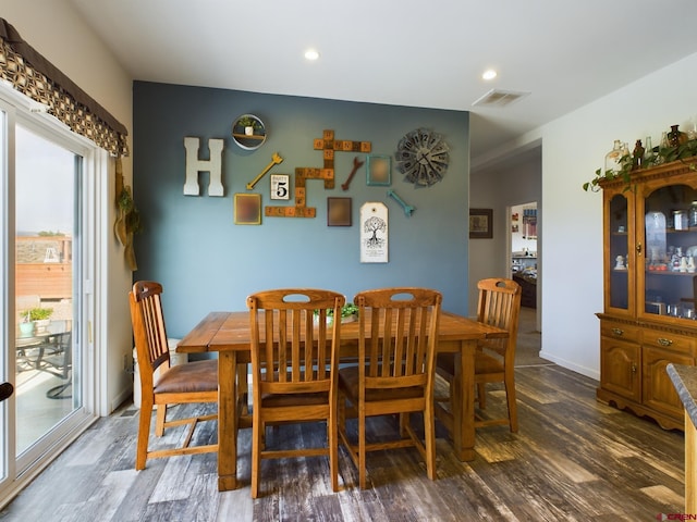 dining area featuring dark wood-type flooring