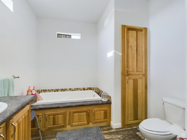 bathroom featuring vanity, toilet, a bathing tub, and hardwood / wood-style floors