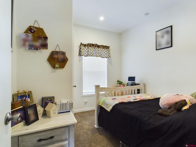 bedroom with dark colored carpet