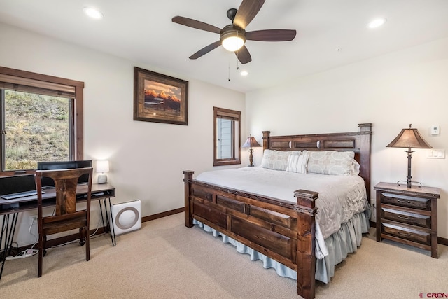 bedroom featuring light colored carpet and ceiling fan