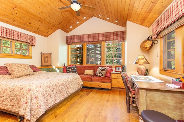 bedroom featuring multiple windows, lofted ceiling, light hardwood / wood-style flooring, and ceiling fan