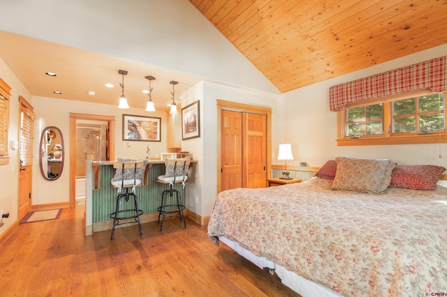 bedroom featuring high vaulted ceiling, wood-type flooring, a closet, wood ceiling, and indoor bar