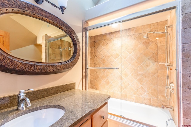 bathroom featuring shower / bath combination with glass door and vanity