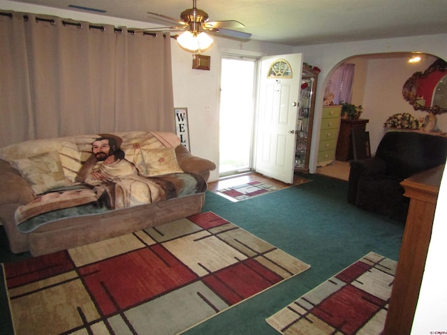 730 Washington St, Monte Vista, CO 81144 - living area featuring carpet floors, visible vents, arched walkways, and ceiling fan
